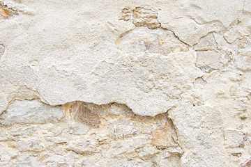 Old beige stone wall background texture