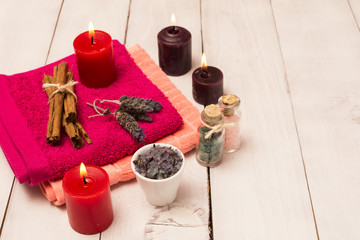 Spa towel and candles with bath salts