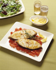 Fish with tomato with lemon and drinks