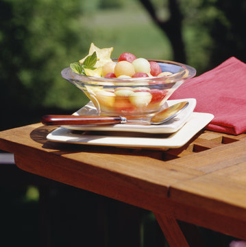 Fruit salad of melon balls outdoors.