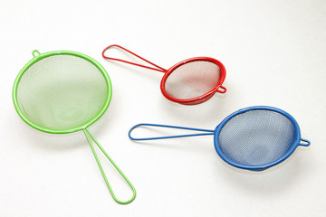 Set of colorful kitchen strainers, close-up