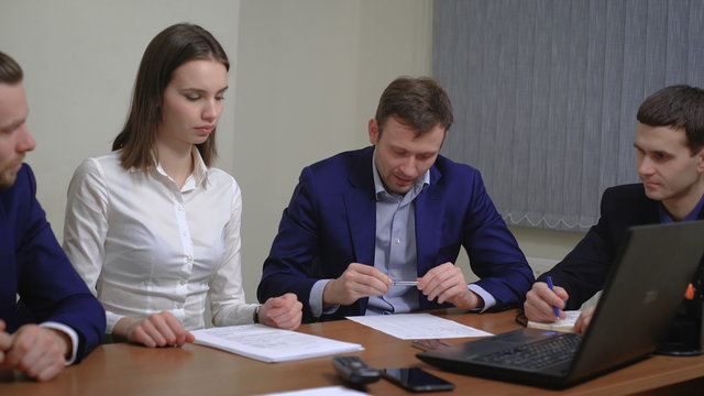 Two business people in elegant suits. Working in team together with documents sign up contract. 