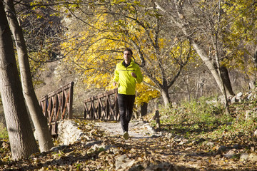 Man running at autumn park