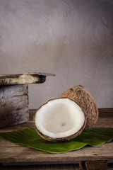 coconuts on banana leaf and coconut grater