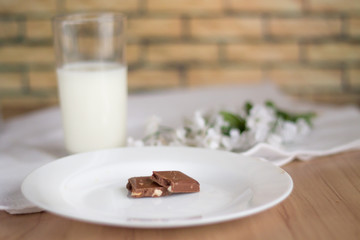 Chocolate on the background of flowers and milk