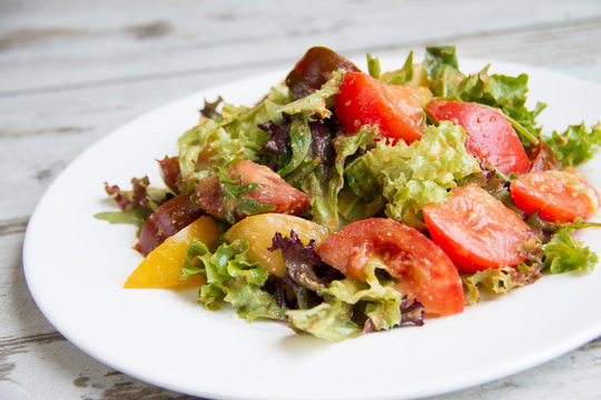 salad of three types tomato with lettuce and sauce