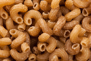 Texture background of raw italian pasta fusilli macaroni made of