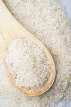 food background. brown rice in a wooden spoon. top view