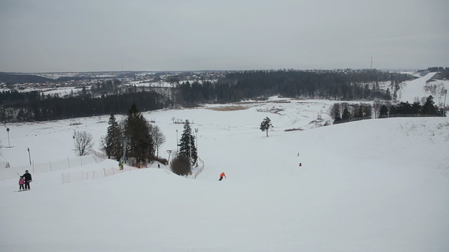 Skiers and snowboarders in winter day.Skiers and snowboarders skiing downhill in the winter season.Skiers and snowboarders enjoying on slopes of ski resort.