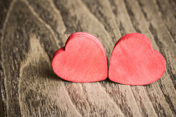 Fototapeta premium Red wooden heart shapes on wooden table.