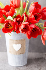 Red tulips on a wooden background.