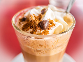 Coffee latte with whipped cream and cinanmon