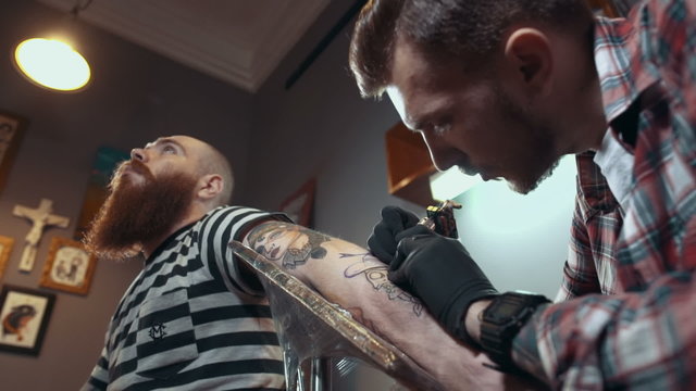 Tattoo artist make tattoo, low angle view