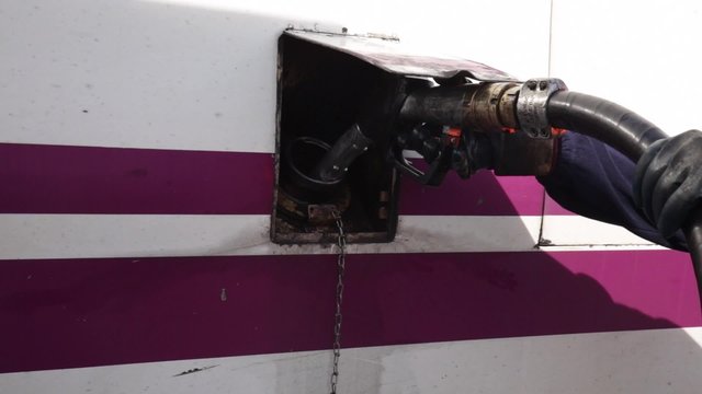 Refuelling worker a train at a station