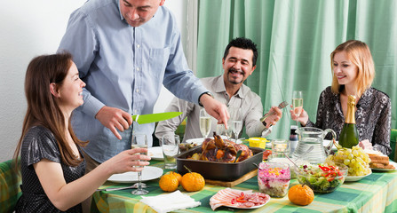 Obraz na płótnie Canvas Group of friends eating at festive table