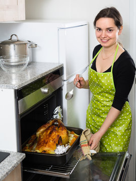 Woman Cooking Capon In Baking Tray.