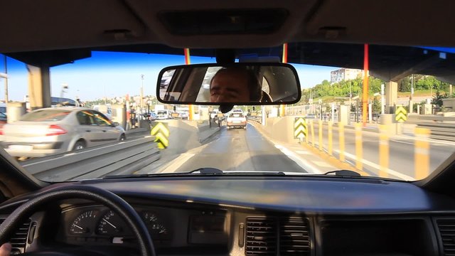 Car driving on the bridge exit on a sunny day. You don't ever have to stop to pay a toll. Auto pass and toll road
