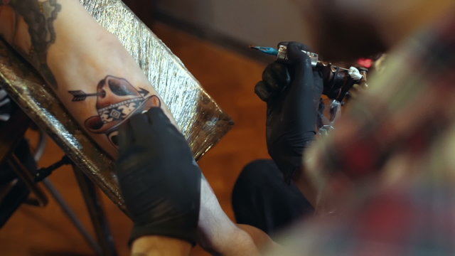 Tattoo artist make tattoo, close up