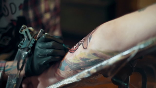 Tattoo artist make tattoo. close up, slow motion, dolly shot