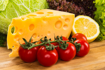 yellow cheese with fresh vegetables