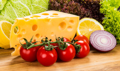 yellow cheese with fresh vegetables