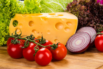 yellow cheese with fresh vegetables