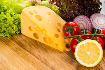 yellow cheese with fresh vegetables