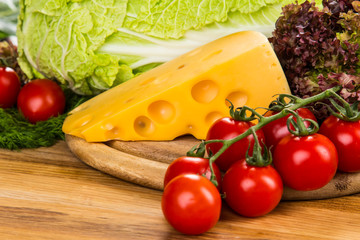 yellow cheese with fresh vegetables