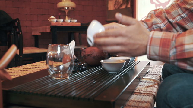 Master of tea doing tea ceremony on the table