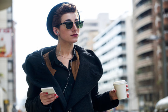 Young beautiful woman with mobile phone and coffee.