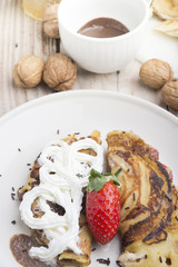 delicious crepes with berries and chocolate sauce, closeup