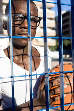 Handsome young man playing basketball.