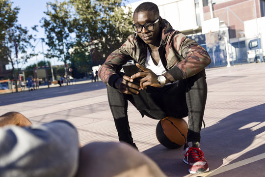 Handsome young woman using his mobile phone.