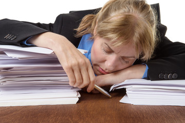 Exhausted businesswoman sleeping on desk