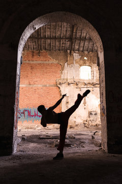 silhouette of man doing martial arts