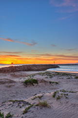 Portrait view of Ventura sunset on camera left behind beach jetty.
