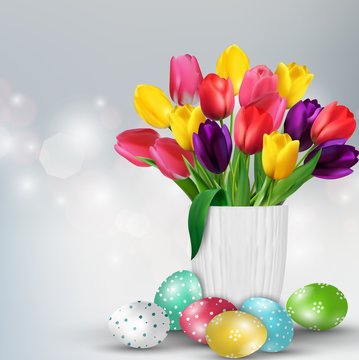 Easter background with colorful eggs and tulips in the glass