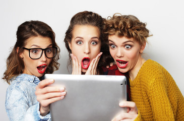  three teen girls friends taking selfie with digital tablet