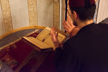 Muslim man reading the koran