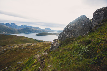 Obraz premium Classic norwegian scandinavian summer mountain landscape view with mountains, fjord, lake with a blue sky, Norway, Lofoten Islands