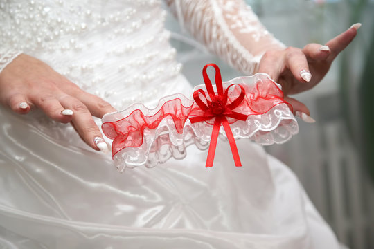 bride shows her wedding garter