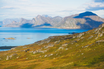 Classic norwegian scandinavian summer mountain landscape view with mountains, fjord, lake with a blue sky, Norway, Lofoten Islands