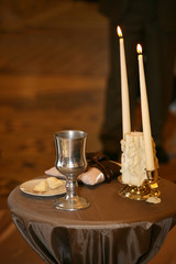 two decorative candles are lit on the wedding ceremony