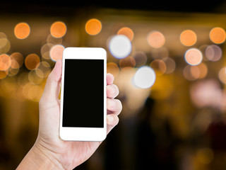 Man hand holding blank screen mobile phone with blur festive gol © littlestocker