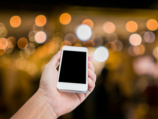 Man hand holding blank screen mobile phone with blur festive gol © littlestocker