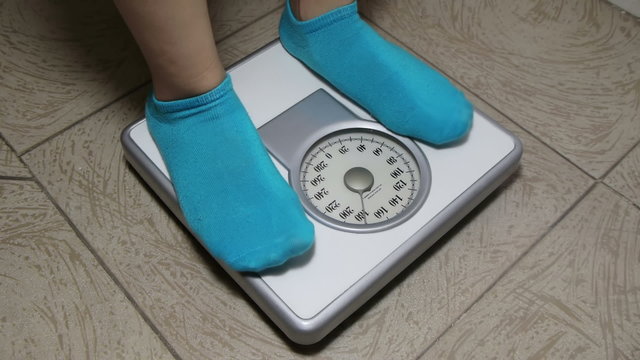 Female with Blue Socks Standing on Weight Scale Sequence With Angles. No Logos Visible just a generic weight disclaimer.