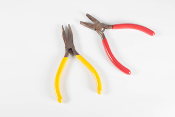 Red pliers on a white background.