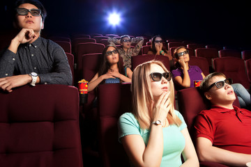 People sitting at the cinema, watching a film