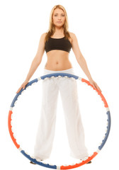 sporty fit girl doing exercise with hula hoop.