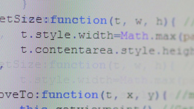 Close-up of computer code running on desktop pc monitor